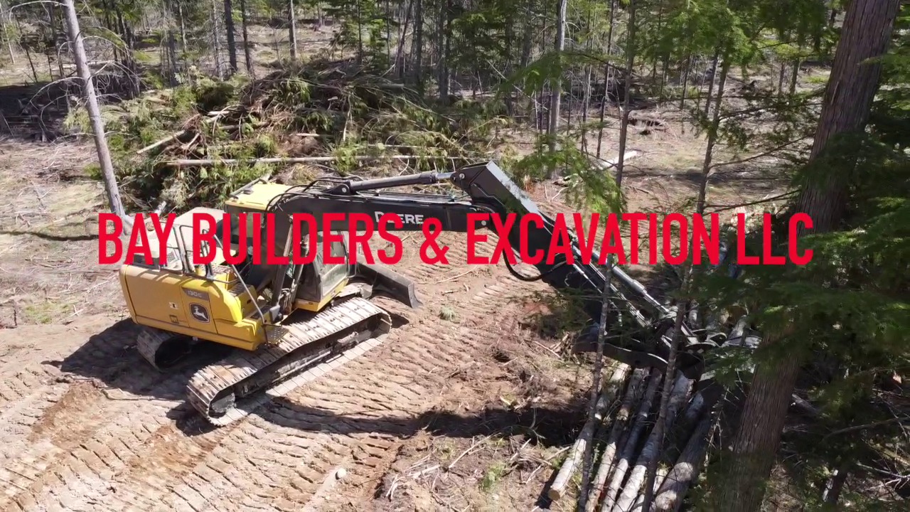 Mini excavator clearing forest — Clark Fork, ID