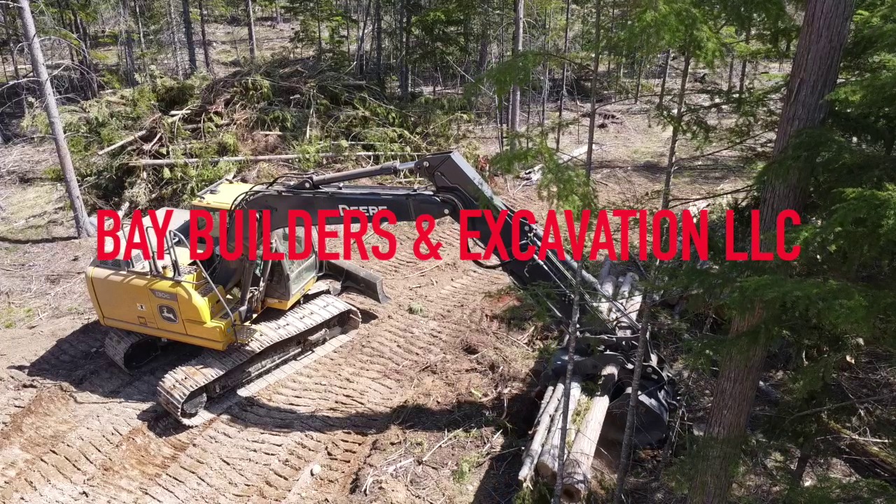 Excavator clearing logs — Clark Fork, ID