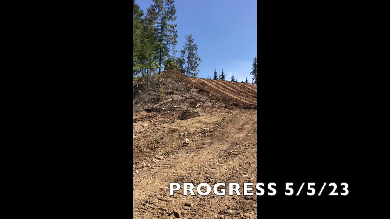 Bulldozer on steep hillside cut — Clark Fork, ID