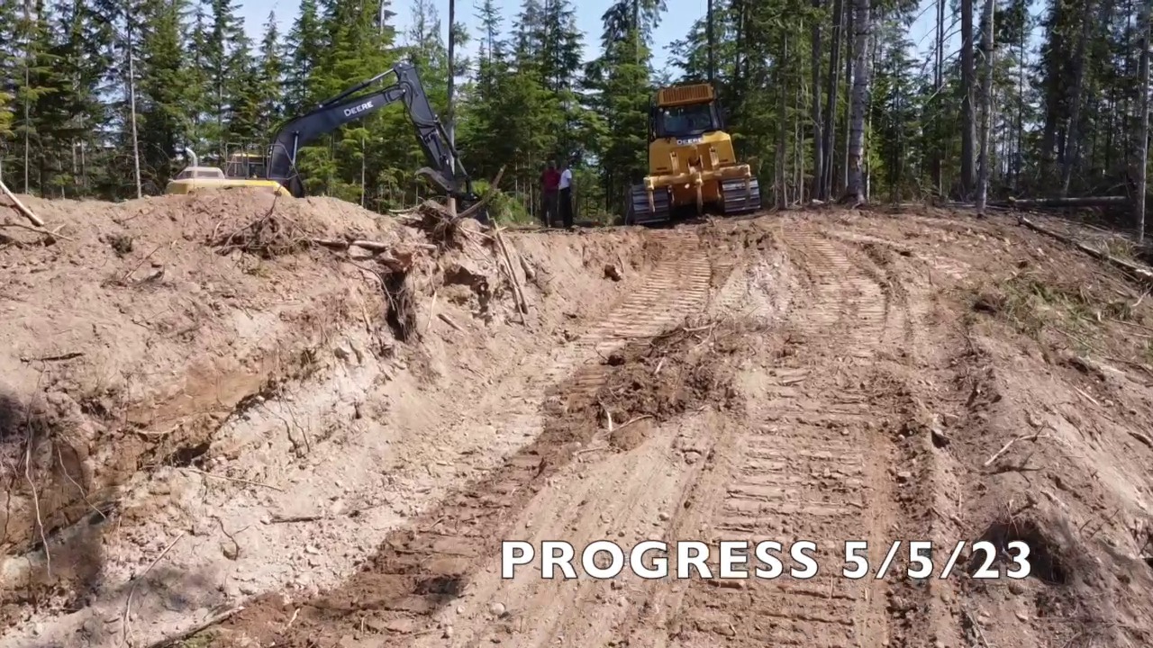 Excavator and dump truck on road construction — Clark Fork