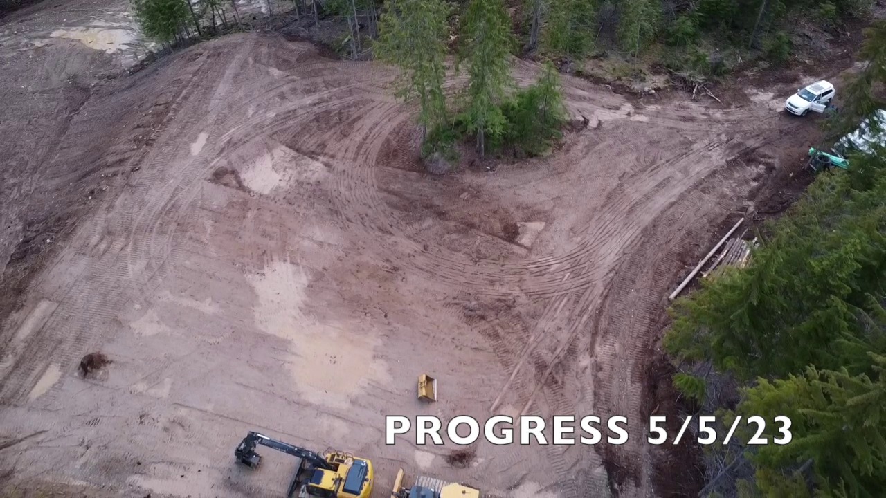 Two machines finishing site grading — Clark Fork, ID